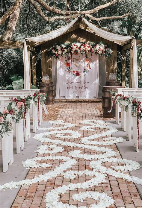 whimsical wedding with a floral backdrop wedding arches outdoors beautiful outdoor wedding