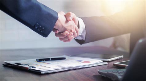 Two Businessmen Shake Hands To Celebrate A Business Deal 1103222 Stock