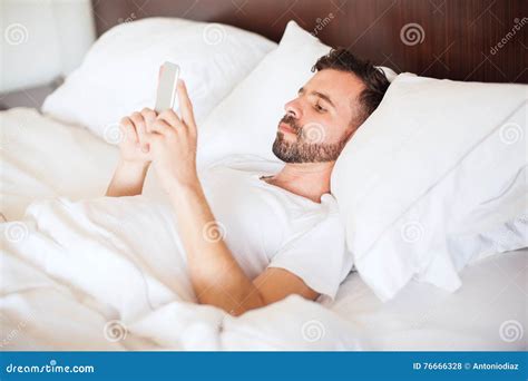 Man Using A Smartphone On His Bed Stock Photo Image Of Lying Male