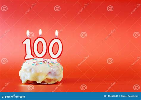 One Hundred Years Birthday Cupcake With White Burning Candle In The