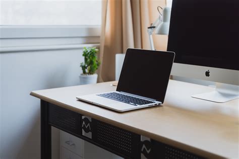 A Macbook On A Clean Computer Desk With An Imac At Apple Computer