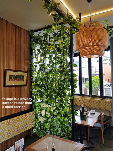 Cafe Uses Artificial Green Vines For Privacy Screens And Pergolas