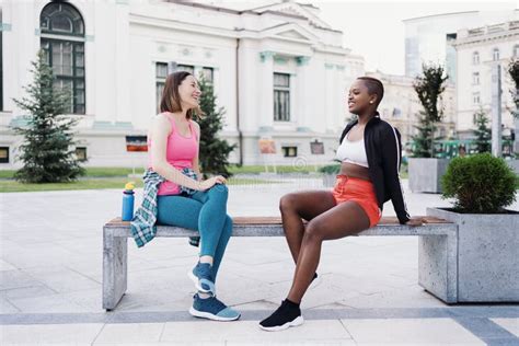 Two Multiethnic Curvy Girls Relaxing After Exercise Session Outdoor