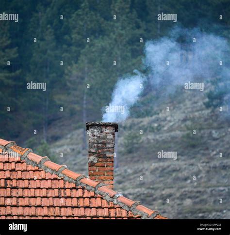 Smoke Raising From A Chimney In Winter Stock Photo Alamy
