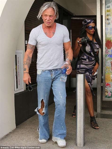 Reversing In Age Mickey Rourke Shows Off Toned Figure In A Tight T Shirt And Distressed Jeans