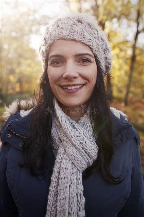 Portrait Of Attractive Woman On Walk In Autumn Countryside Stock Photo