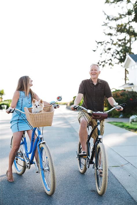 Healthy Active Couple Enjoying Life Riding Cruiser Bikes In Sun By