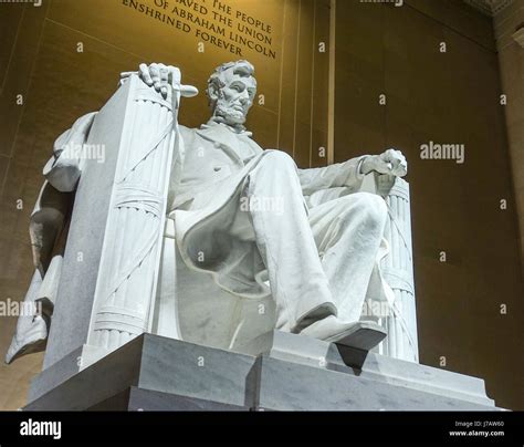 The Statue Of Abraham Lincoln Sitting In A Chair At Lincoln Memorial In