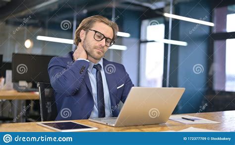 Tired Businessman Having Neck Pain In Office Stock Image Image Of