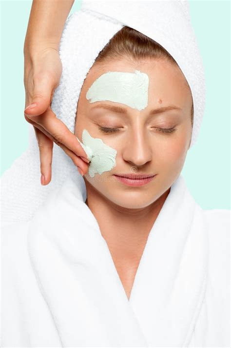 Beauty Treatments Woman Applying Facial Mask At Spa Stock Photo