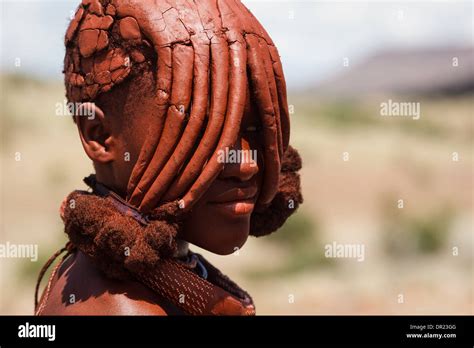 Portrait Of Himba Woman With Traditional Mud Caked Hairstyle Covering Her Eyes In Damaraland