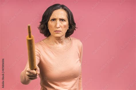 A Very Angry Senior Mature Aged Lady Holding A Rolling Pin And Threatening To Whack Someone With