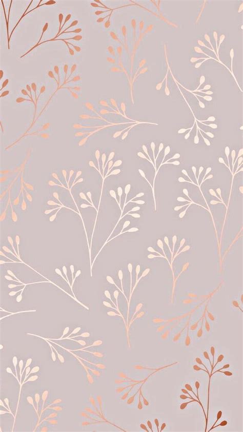 A Pink And Gold Wallpaper With Leaves On It