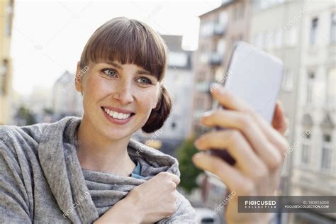 Smiling Woman Taking Selfie On Balcony — Only One Woman Cheerful