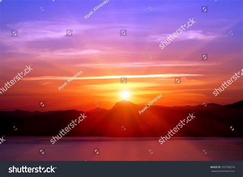 Sunset Over Mountains Near Sea Stock Photo 102708518