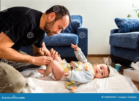 Father Changing His Baby S Diaper While Caressing Him Affectionately