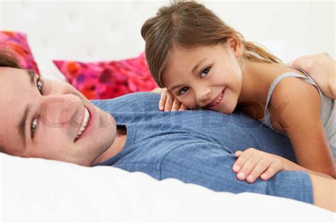 Father And Daughter Lying In Bed Together Stock Image Colourbox