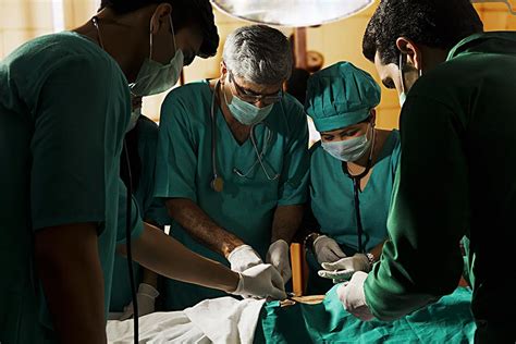 indian surgeons operating on a patient in hospital operation theater