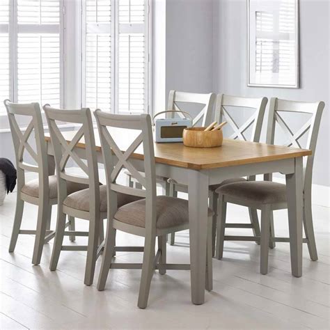 Gray dining room with wooden dining table complementing the buffet tables with striped chairs and a candle chandelier. Bordeaux Painted Light Grey Large Extending Dining Table + 6 Chairs, Seats 6-8 | Costco UK
