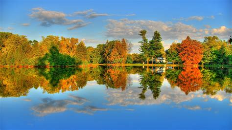 Lake Surrounded By Orange Green Autumn Trees Under White