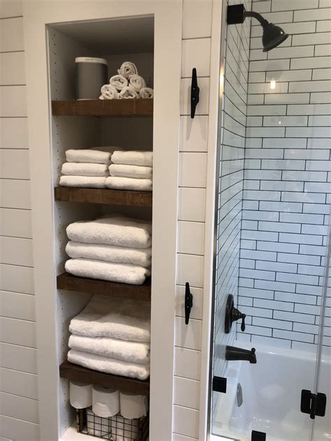 These unique shelves provide you with a trendy place to store all manner of toiletries and even candles and air fresheners, while simultaneously giving you a cute space to hang a towel. Modern Farmhouse Bathroom with wood vanity, shiplap walls ...