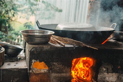 Cooking Using Firewood By Stocksy Contributor Pansfun Images Stocksy