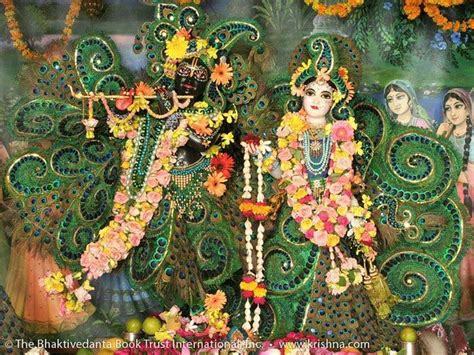 An Idol With Flowers And Other Decorations In Front Of A Painting On