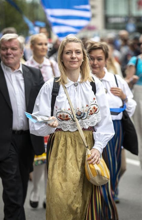 Estonian People In Traditional Clothing Walking The Streets Of Tallinn