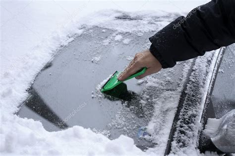 Removing Snow From The Car Windshield — Stock Photo © Zwolafasola 1650013