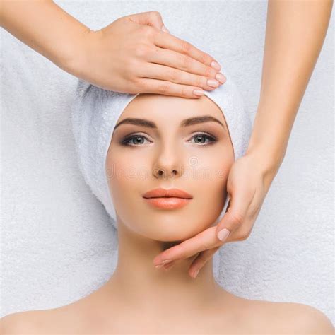 Young And Healthy Woman Gets Massage Treatments For Face Skin And Neck