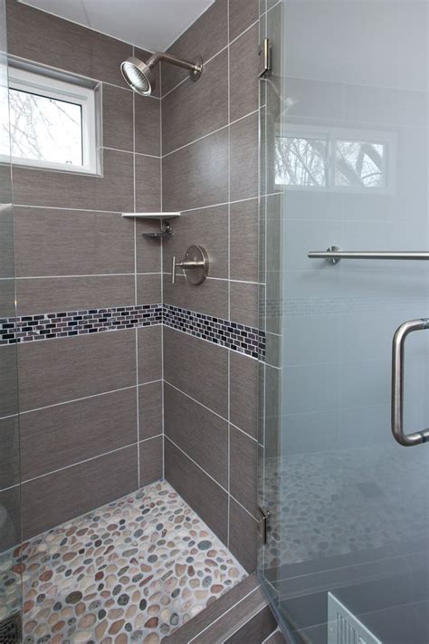 These modern shower tile ideas and designs for 2021 will have you looking to redesign your bathroom! Grey porcelain tile was chosen for the floor, shower walls ...