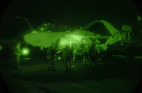 sailors secure an ea 6b prowler to the flight deck of nuclear powered aircraft carrier uss
