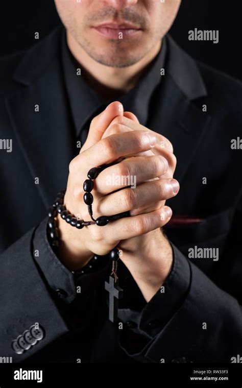 Christian Person Praying Low Key Image Hands Of A Man In Black Suit