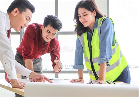 Construction Workers A Female Architect And Two Male Engineers