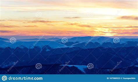 Sunset Over Mountains Peaks Covered With Snow In Winter Clear Day Stock