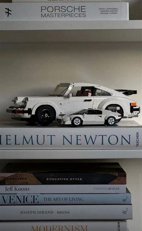 Books Stacked On Top Of Each Other In Front Of A White Car