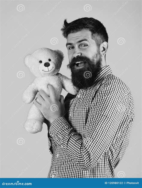 Man Holds Teddy Bear On Blue Background Stock Photo Image Of Cuddle