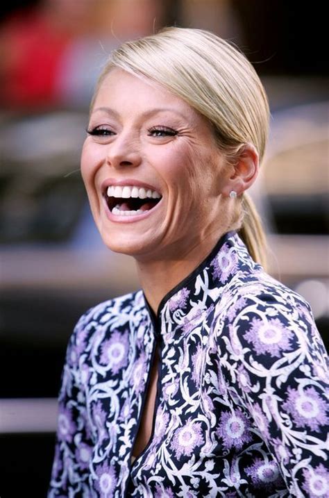 A Smiling Blonde Woman With Her Mouth Open