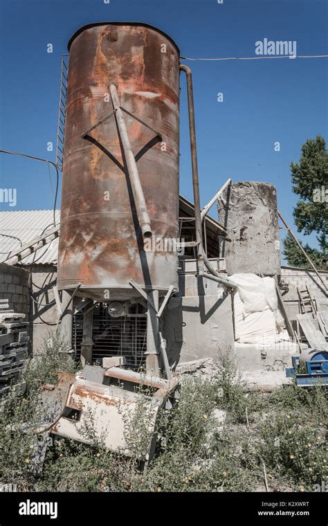 Old rusty industrial cement storage tank. Part of a small cement Stock