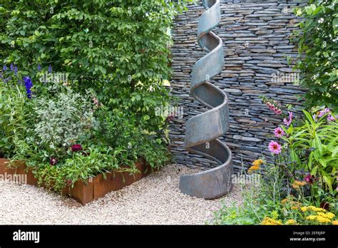 Small English Courtyard Garden With Spiral Sculpture Dry Stone Wall