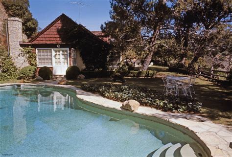 An Outdoor Swimming Pool In Front Of A House