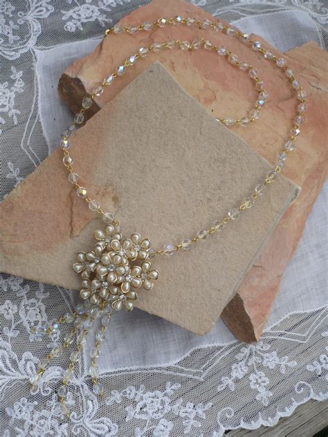 this beautiful handcrafted necklace is 29 long a gold and crystal chain has a vintage pearl