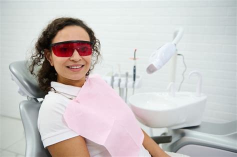 Premium Photo Attractive Middle Aged Woman Sitting In Dentists Chair