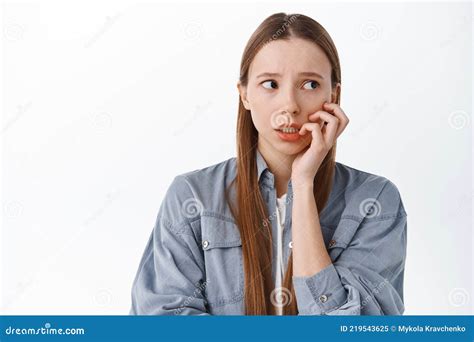 Nervous Girl Biting Fingers And Looking Aside With Worried Anxious