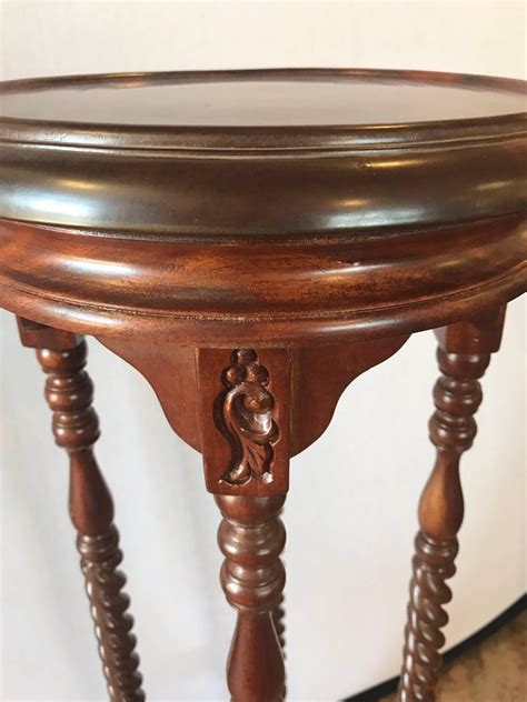 Item features solid wood construction, black ebonized finish with gold accents, carved reeded column. Pair of Carved Mahogany Plant Pedestal Stands Display ...