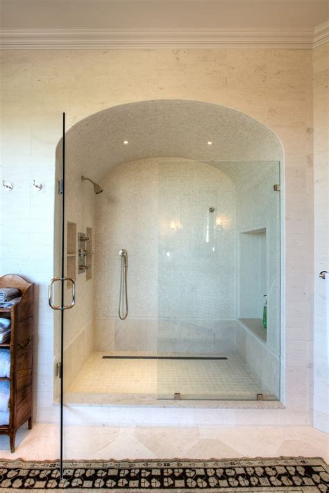 Empower your shower with a new shower door, available in a variety of frame finishes and glass styles from the best brands. Arched Shower with White Stone Tile and Glass Doors Bath ...