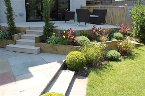 Raised Composite Millboard Decked Terrace With Sleeper Planters Leading