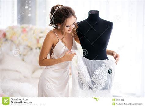 A Beautiful Bride In A Silk Night Dress Takes Off Her Wedding Dress