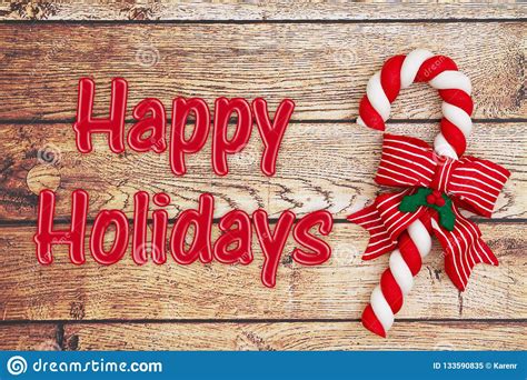 Candy Cane On A Weathered Wood With Text Happy Holidays Stock Image