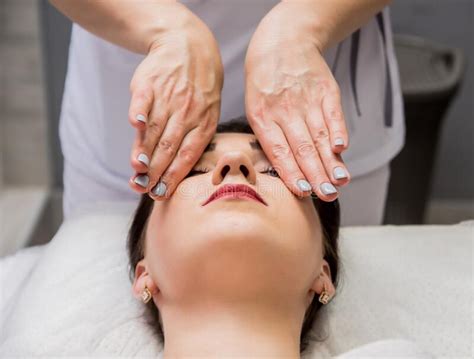 Beautiful Young Woman Enjoying Head Massage In Spa Salon Cosmetology